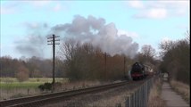 Steam Train Chuffing along with a Passenger Train on its way to the Railway Train Station