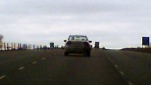 PICT0091. car driving with bumper hanging from back.tore off car but still driving the qq2 south of red deer alberta canada. 120 kph. accident happened. road rage. crazy drivers are everywhere. https://www.dailymotion.com/dummies101 hyway to hell.