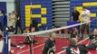 Prince Harry throws a ball in front of Meghan at seated volleyball trials