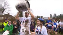 11th annual UK wife carrying race takes place in Surrey, England