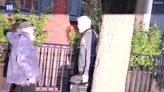 George Clooney receives a gift from Radio Man while leaving his house in New York