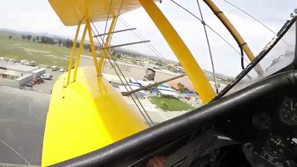 Woman drops from UPSIDE-DOWN biplane for California skydive