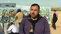 Palestinian artists decorate tents with paintings near border