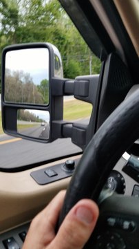 Woman Steals Car and Drives Away with Man on Hood