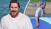 Christian Bale hits the waves in large T-shirt and trunks while on vacation with family in Hawaii.