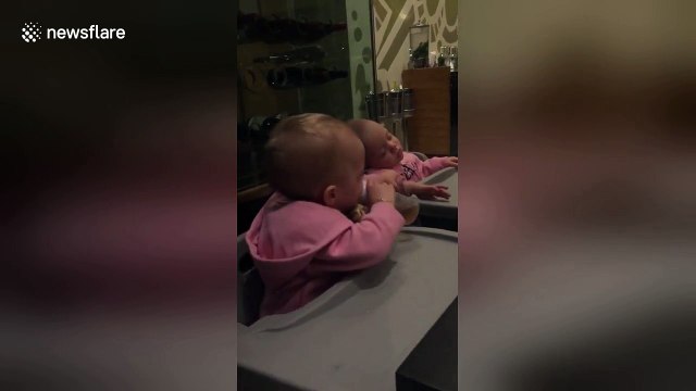 Bored twin desperately tries to wake her napping sister to play