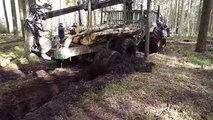 Forwarder Kockums pulls Belarus Mtz 892 forestry tror, wet conditions, difficult road