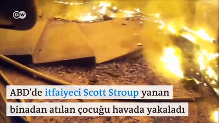 ABD&#39;de bir itfaiyeci, yangından kurtarılması için balkondan atılan çocuğu havada yakaladı
