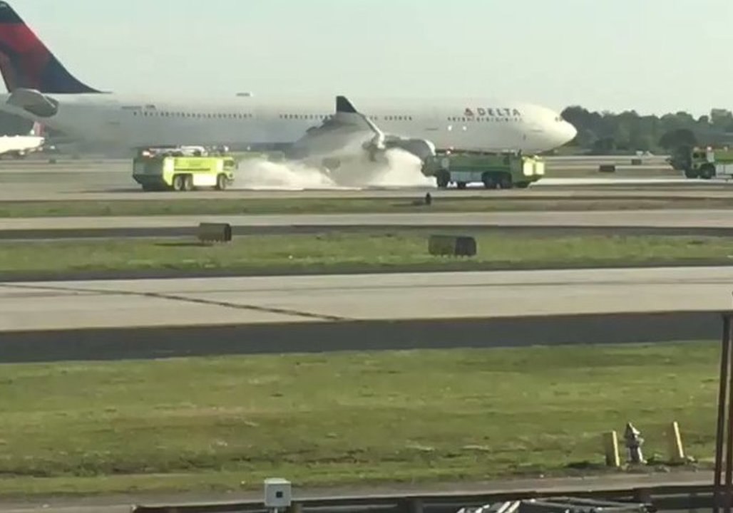 Atlanta Airport Firefighters Spray Foam on Delta Plane's Smoking Engine