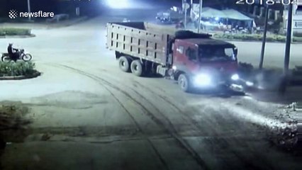 Scooter driver cheats death after rolling under lorry