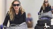 Sarah Jessica Parker looks effortlessly chic as she lugs three bags through JFK airport in heels