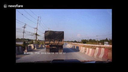 Going, going gone! Truck topples over after skidding on dusty road