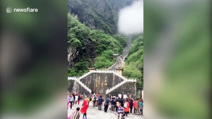 Stunning fog passes through China's famed Tianmen Cave