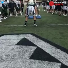 Football player jukes tackler with front flip