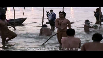 Naga sadhus have a holy bath at Ardh Kumbh Mela