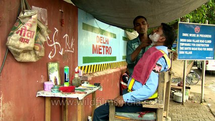 Road-side barber at work near Delhi Metro- old and new co-exist