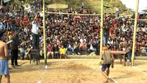 Naga boy takes a high jump to kick piece of meat - meat-kicking competition