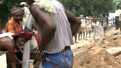 Workers lay underground cable in Delhi - archaic method for modern tech