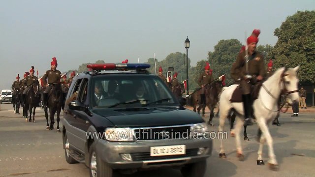 After Indian Army horses pass, the poo collectors get going!