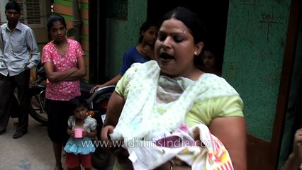 Indian transgenders or hijras dance at home of new-born baby