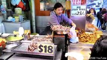 Hong Kong Street Food. Cooking Grilled Octopus in the Streets of Mong Kok