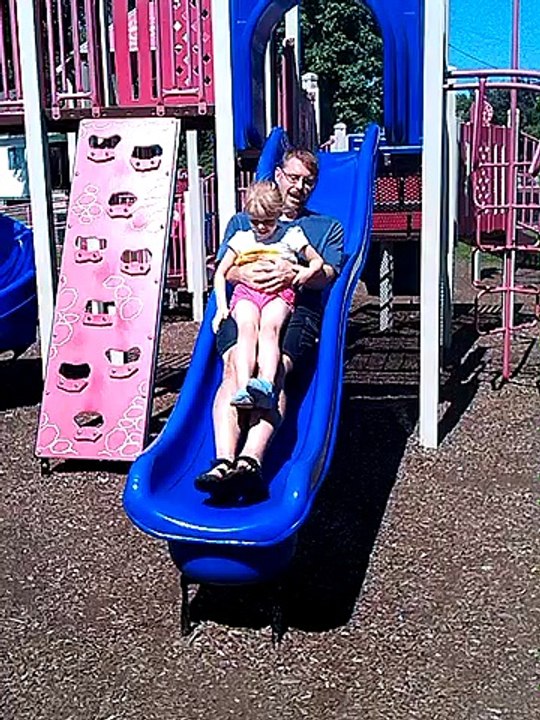 Emma Going Down The Side with her Dad at The Park.