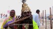 Sadhu with sea-shell embedded flute,  others parade on camel to Ganges