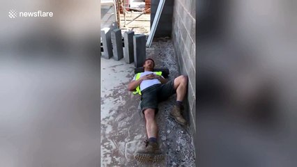 Hilarious moment builder topples concrete slabs to wake up napping mate