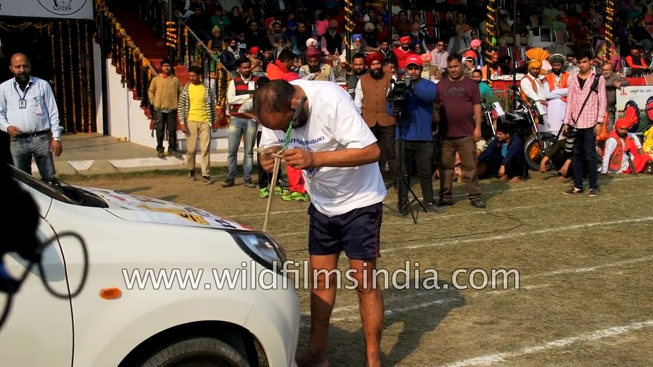 Only in India - Man pulls car with his ears, for competitive fun!