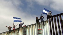 'Caravan' migrants at US-Mexico border vow to wait