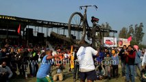 Lifting plough tied to a bicycle with mouth -only in India