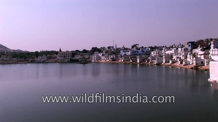 Fishing for money using a magnet from sacred Pushkar Lake, Rajasthan