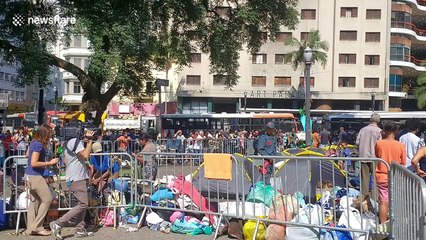 Survivors live in tents next to Sao Paulo tower as it still smoulders