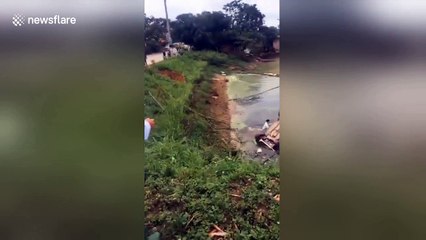 Moment driver is pulled out of hatchback that plummeted into lake