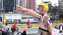 Protesters burn Donald Trump effigy for May Day in Bogota