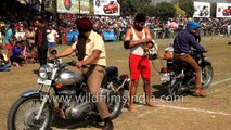Indian holds on to two Royal Enfield bikes driving in opposing directions
