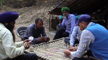 Sardar Taxi Drivers sit around and play taash or cards in Delhi
