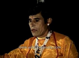 Indian balancing act- water pot atop glasses and bullock cart wheel