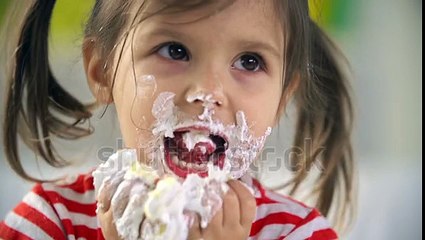 Close Up Of Adorable Little Girl Devouring Cake With Her Hands