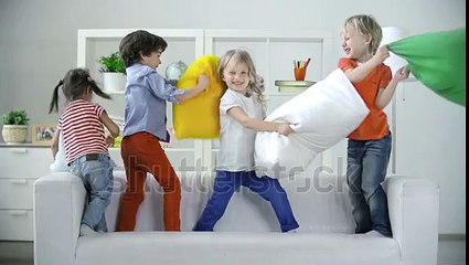 Four Kids Playing On Sofa Pillow Fighting