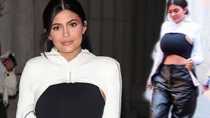Kylie Jenner flashes her flat stomach in a crop top and a barely there hoodie for dinner in New York City