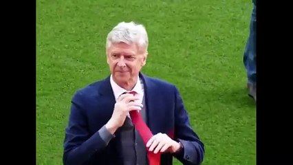 Arsene Wenger hands his tie to a young supporter at his final Arsenal home game