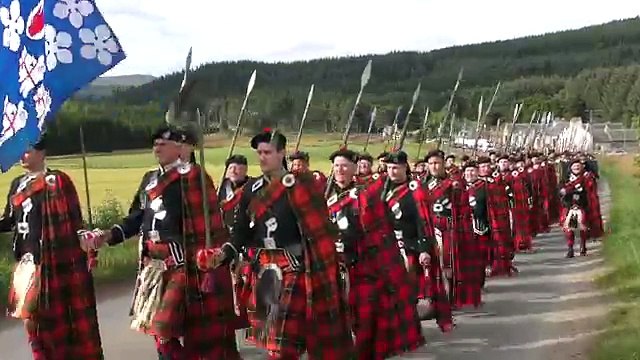 2016 Lonach Highlanders march through Strathdon Scotland together with the Atholl Highlanders
