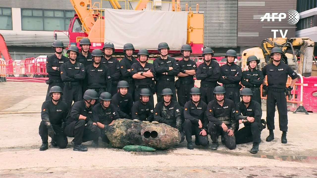 Hong Kong police pose with defused WWII bomb