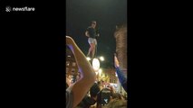 England fan whips crowd into frenzy after scaling lamppost
