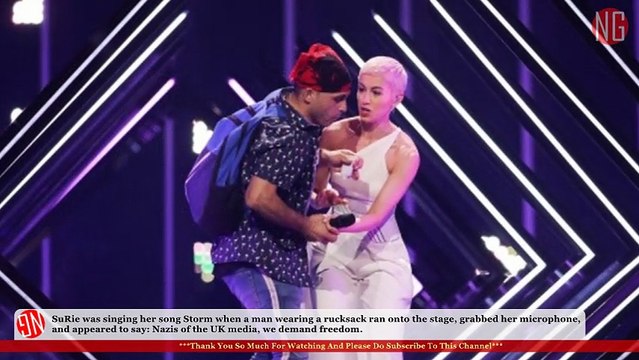 Man Invades SuRie While Singing, Shouts 'Nazis of the UK Media, We Demand Freedom'