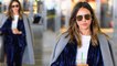 Jessica Alba wows in blue velvet ensemble and dazzling silver sneakers as she jets into New York City in style