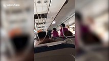 Video captures chaos inside plane after co-pilot is nearly sucked out of cockpit window