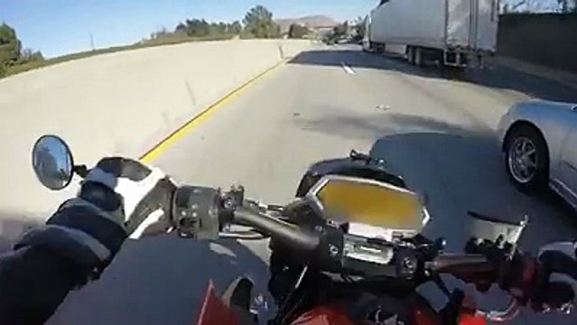 Dude is lucky to be alive! Motorcyclist Crashes And Slides Underneath Semi