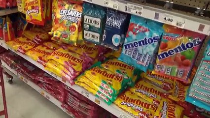 Kid goes shopping and buys lots of candies